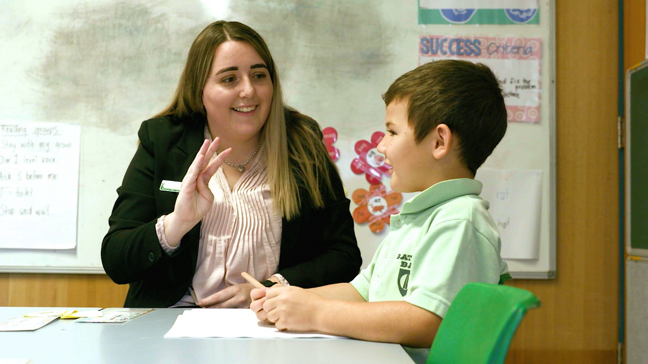 Female teacher with young male student 